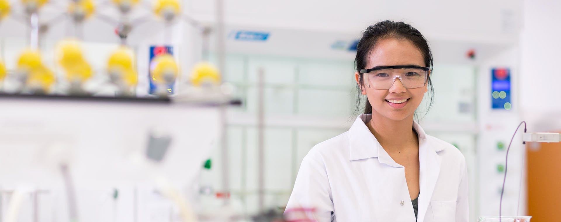 Student in laboratory smiling