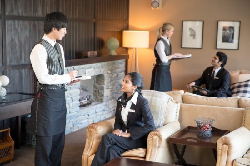 Hospitality students practise their service skills as part of their coursework in a hotel lodge
