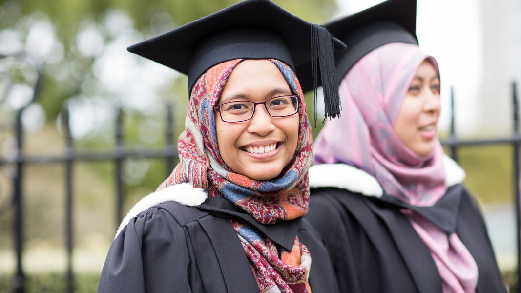 Students in hijab and graduation gown