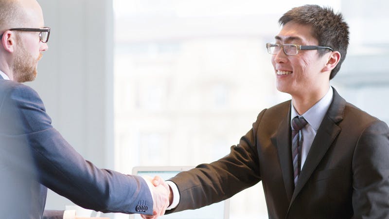 A student in New Zealand shakes hands with a prospective employer